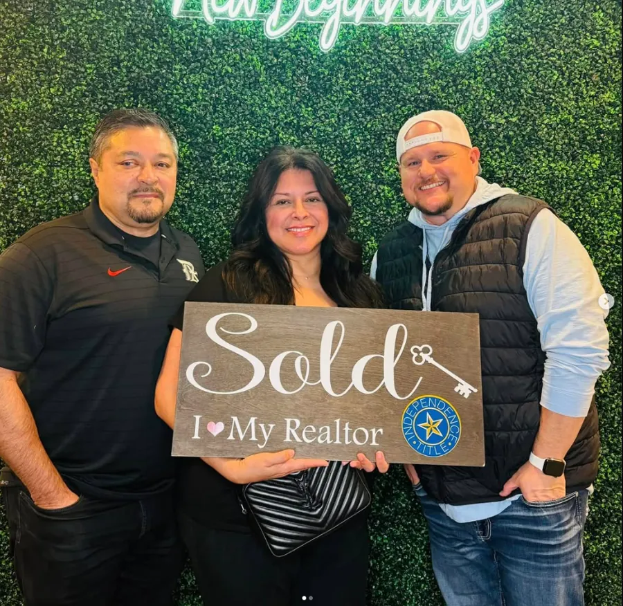 Joey with clients holding Sold signs