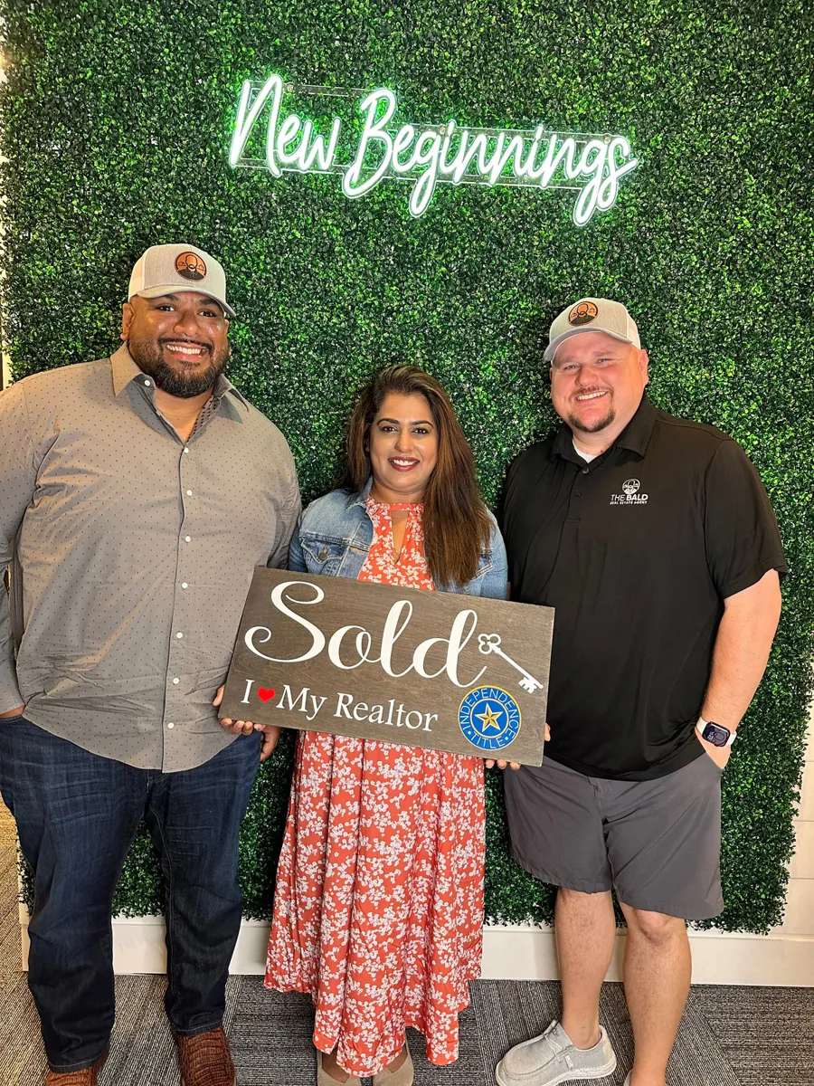 Joey with clients holding Sold signs