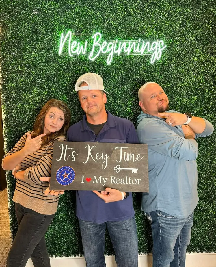 Joey with clients holding Sold signs