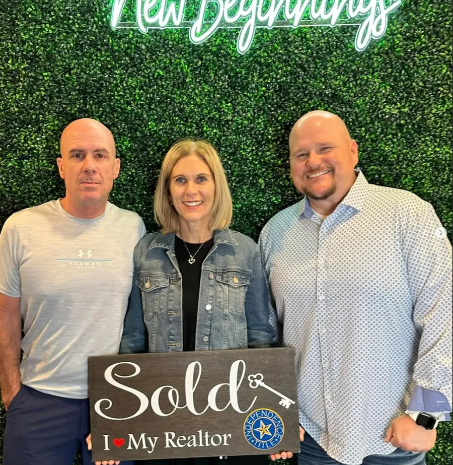 Joey with clients holding Sold signs