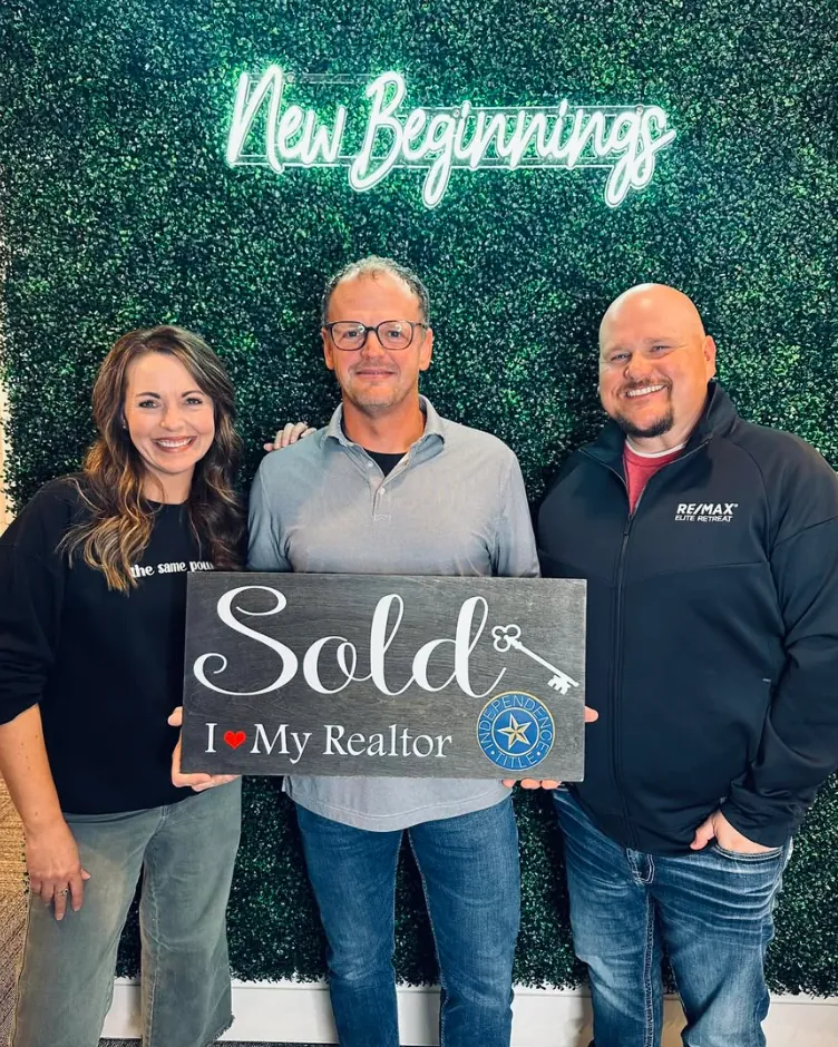 Joey with clients holding Sold signs