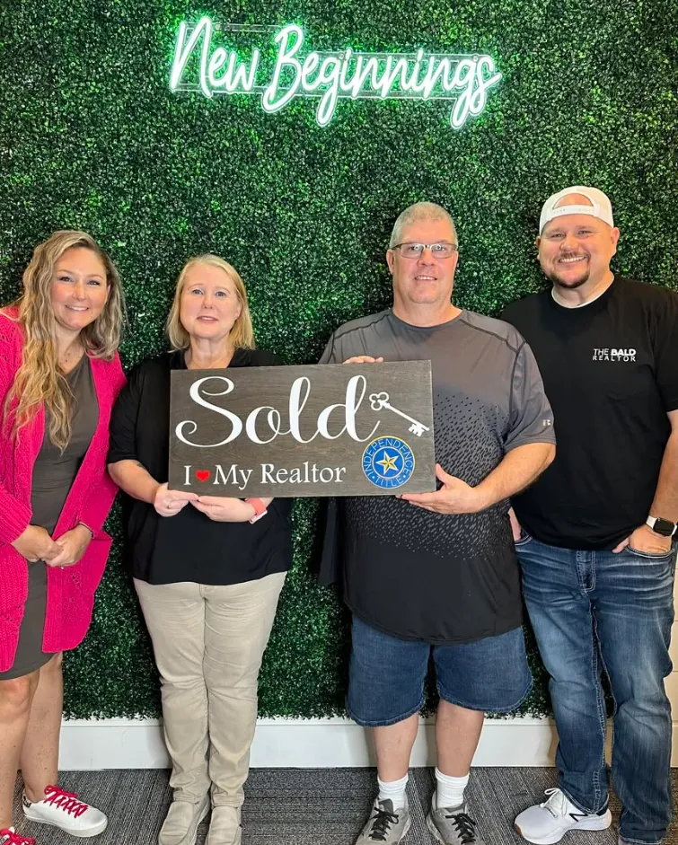 Joey with clients holding Sold signs