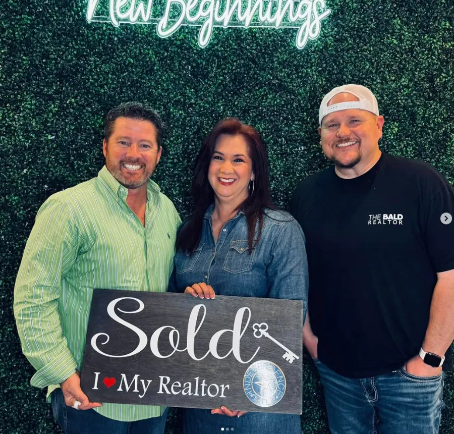Joey with clients holding Sold signs