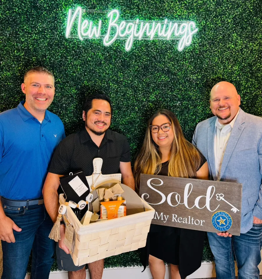 Joey with clients holding Sold signs