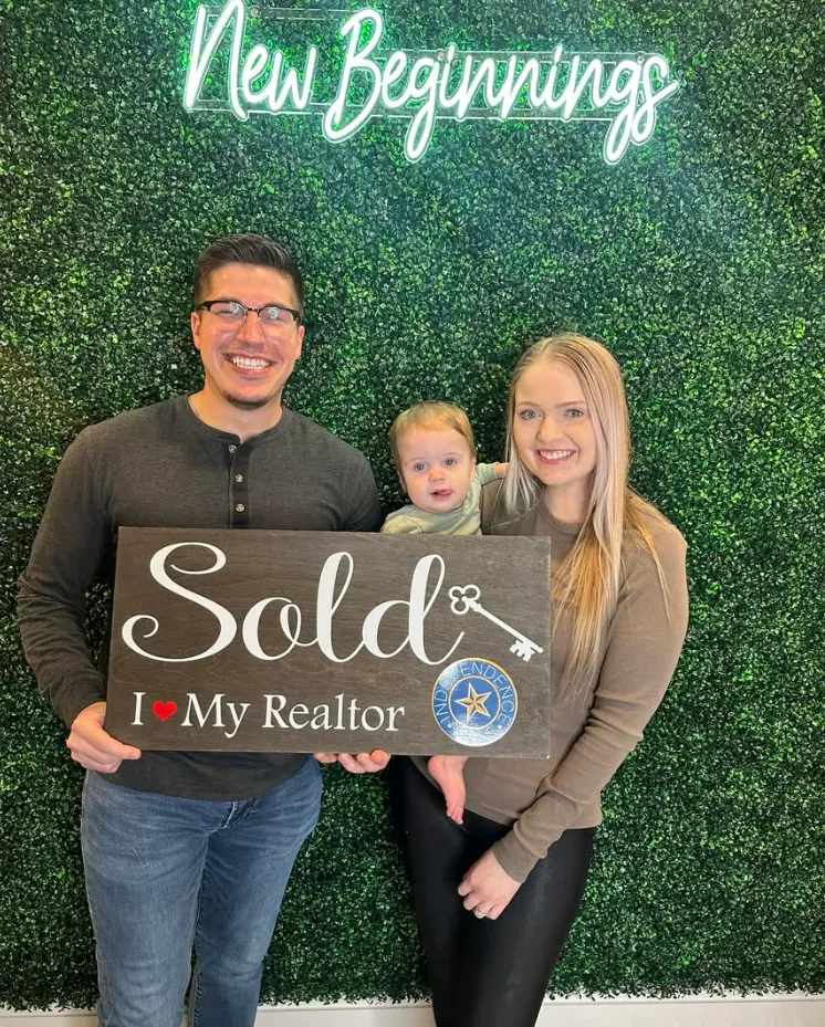 Joey with clients holding Sold signs